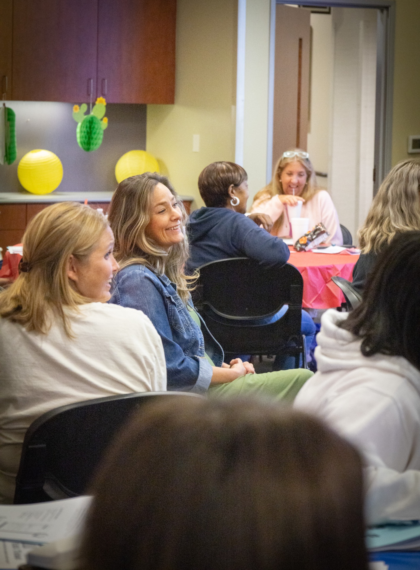 Teachers laughing and engaging during Sally's PD training